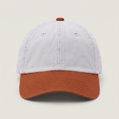 Plain two tone dad cap with a white crown and a rust peak, front view with no logo
