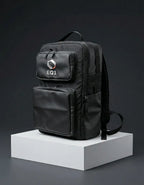 Angled side view of a black backpack with two front zipper pockets and shoulder strap
