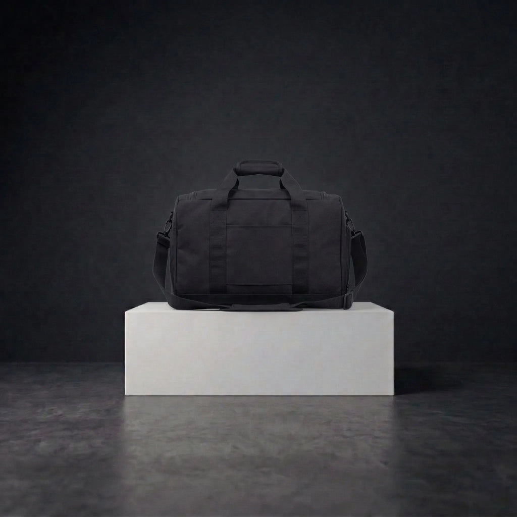 Back view of black duffle bag with shoulder straps