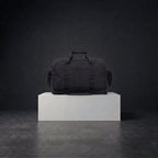 Back view of black duffle bag with shoulder straps