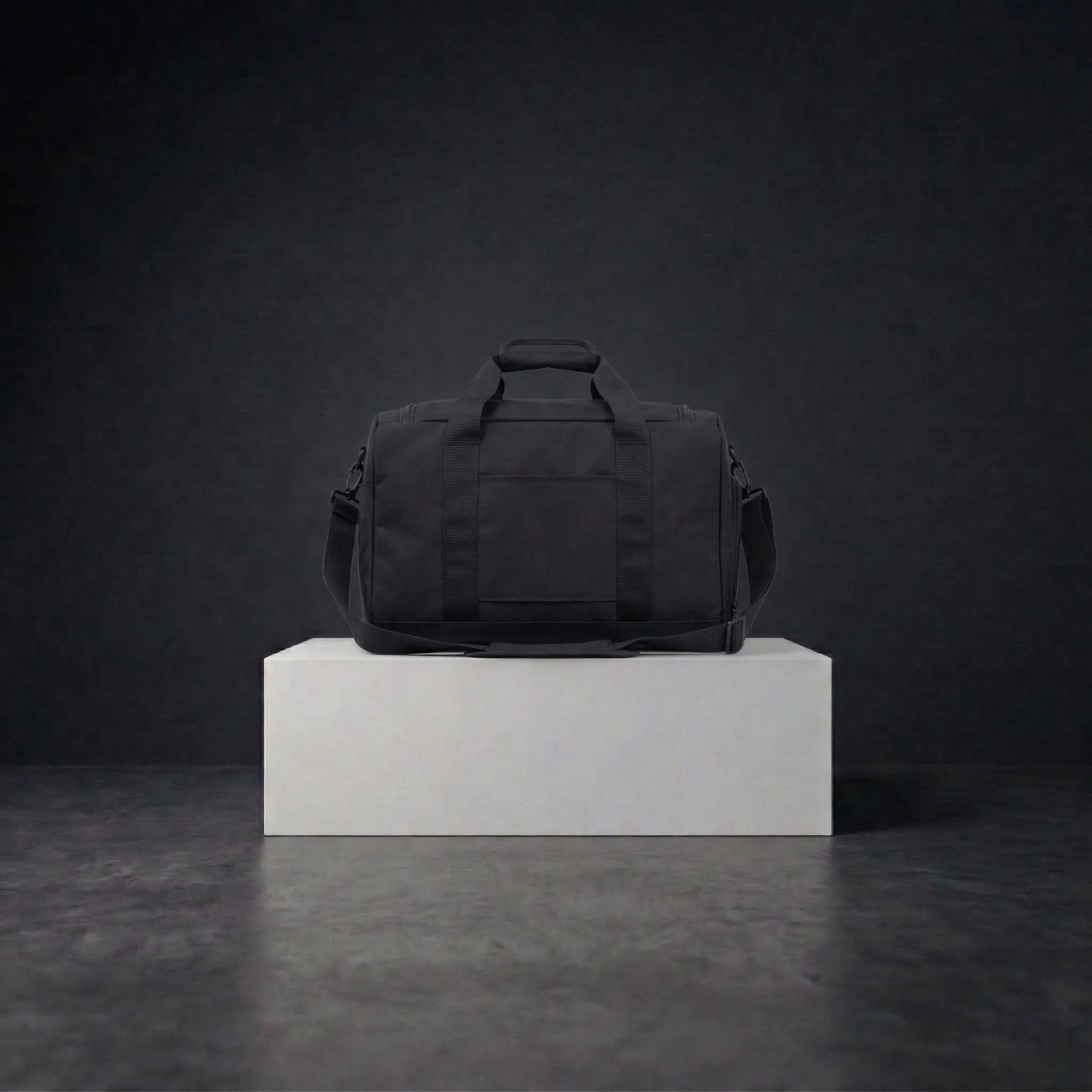 Back view of black duffle bag with shoulder straps