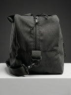 Black EQ1 duffel bag with sturdy handles, adjustable shoulder strap, and spacious travel-friendly design placed on a white platform.