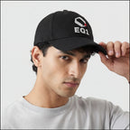 Person adjusting a black EQ1 cap while wearing a light gray shirt