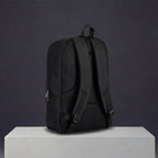 Black travel backpack with cushioned back panel and adjustable shoulder straps