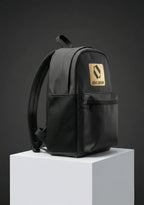 Side angle view of black backpack with gold accents