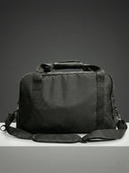 Side view of black duffel bag with sturdy handles and structure