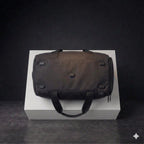 Bottom view of black EQ1 duffle bag with reinforced base and durable support feet