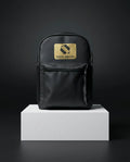 Front view of black backpack with gold accents and clean design