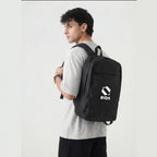Male model carrying black EQ1 backpack with sleek urban lifestyle design