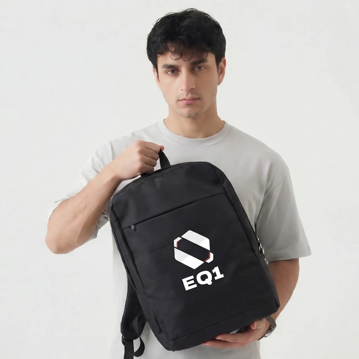 Black EQ1 backpack for office, travel, and daily use shown with model