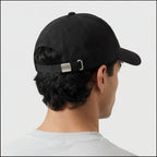 Back side view of black baseball cap with adjustable metal strap closure