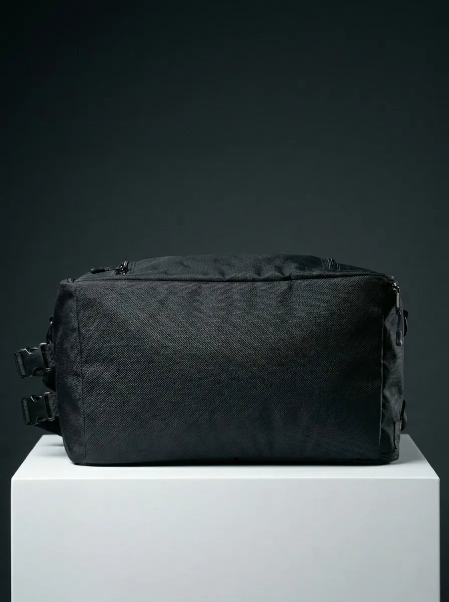 bottom view of black EQ1 duffel bag featuring durable fabric, zipper closure, and compact travel-friendly structure on a white platform.