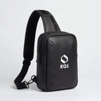 Close-up of black EQ1 sling bag with adjustable strap and zipper compartment detail