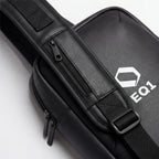 Close-up of black EQ1 sling bag strap with zipper pocket and adjustable buckle