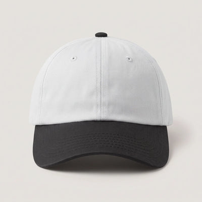 Plain two tone dad cap with a white crown and a black peak, front view with no logo