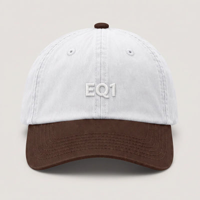 Two tone dad cap with a white crown and a brown peak, EQ1 embroidery on the front