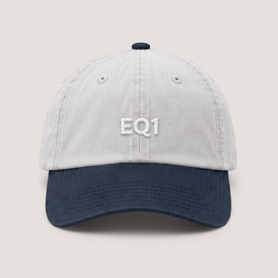 Two tone dad cap with a white crown and a navy peak, EQ1 embroidery on the front