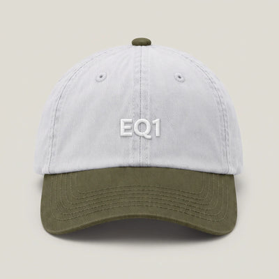 Two tone dad cap with a white crown and an olive peak, EQ1 embroidery on the front