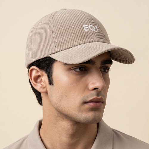 Male model wearing the beige corduroy baseball cap with the EQ1 mark on the front