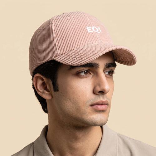 Male model wearing the blush pink corduroy baseball cap with the EQ1 mark on the front