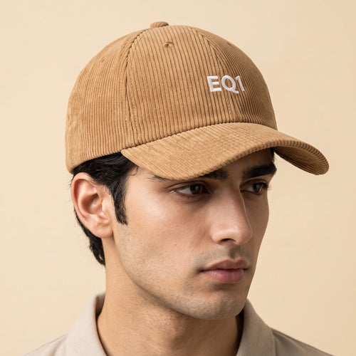 Male model wearing the camel corduroy baseball cap with the EQ1 mark on the front